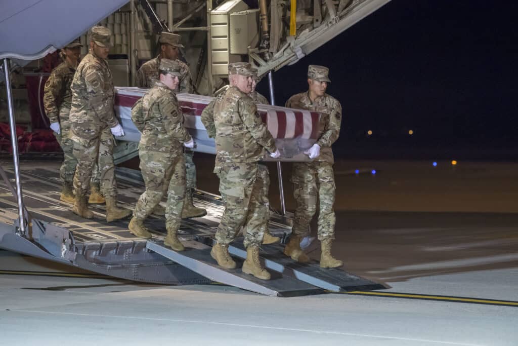 A U.S. Air Force carry team transfers the remains of Ensign Joshua K. Watson, of Coffee, Ala., at Dover Air Force Base, Del., Dec. 8, 2019. Watson was assigned to the Naval Aviation Schools Command, Naval Air Station Pensacola, Fla. (U.S. Air Force Photo by Senior Airman Christopher Quail)