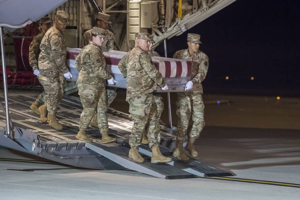A U.S. Air Force carry team transfers the remains of Mohammed S. Haitham at Dover Air Force Base, Del., Dec. 8, 2019. Haitham was assigned to the Naval Aviation Schools Command, Naval Air Station Pensacola, Fla. (U.S. Air Force Photo by Senior Airman Christopher Quail)
