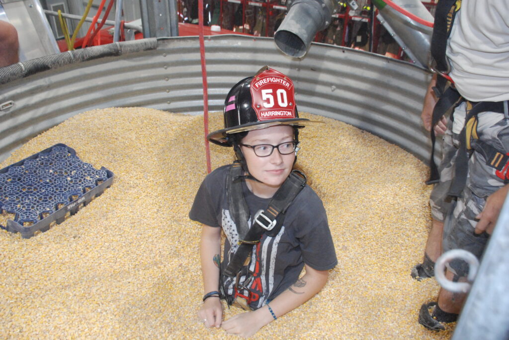 Volunteer firefighter Makayla Parson helped demonstrate how the grain bin rescue tube works last year at the Harrington Fire Department after they received the award from Nationwide.