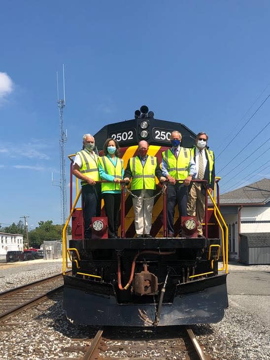From left: Delaware Department of Agriculture Secretary Michael Scuse, Congresswoman Lisa Blunt Rochester, U.S. Senator Chris Coons, U.S. Senator Tom Carper and Carload Express President and CEO Mark Rosner celebrate an $18.8 million grant award from the U.S. Department of Transportation to Delmarva Central Railroad to fix its 188 miles of rail and bridges from Delaware to Virginia.