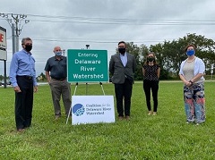 Governor Carney, Representative Pete Schwartzkopf, DelDOT Deputy Secretary Nicole Majeski, Coalition for the Delaware River Watershed State Policy Manager Kelly Knutson, and Delaware Nature Society Director of Advocacy and External Affairs Emily Knearl with the new sign