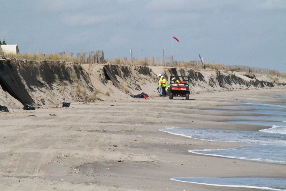 Crewmembers from Lewis Environmental, a remediation contractor, conducts cleanup operations of oil patties that washed ashore at various locations on the Delaware Bay coastline between Fowler Beach and Cape Henlopen, Delaware, Oct. 21, 2020. A unified command consisting of the United States Coast Guard and Delaware Department of Natural Resources and Environmental Control (DNREC) has been established as cleanup efforts continue. (Courtesy photo/Released)