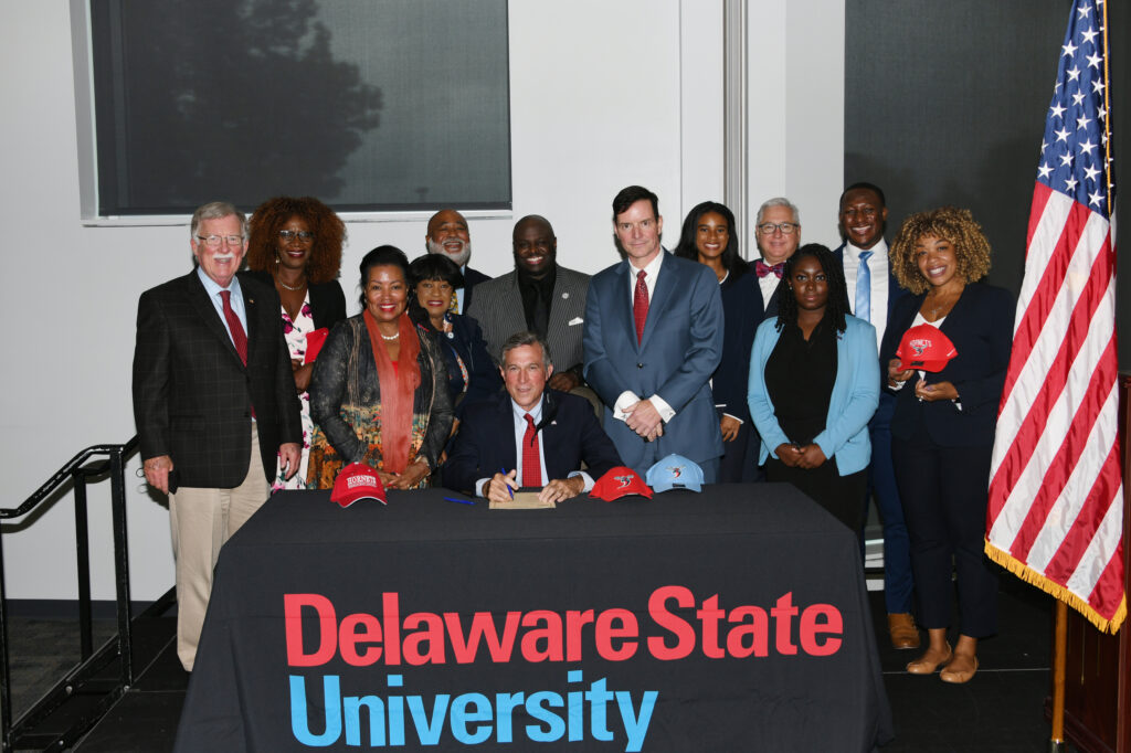 nspire Signing – Gov. John Carney and a crowd of legislators, DSU officials and students, just prior to the governor’s signing of the legislation. Photo courtesy of DSU