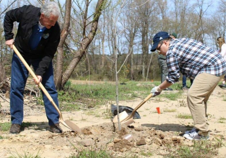  DNREC Secretary Shawn M. Garvin, left, works with a colleague to plant another tree in the Tree for Every Delawarean Initiative whose goal is to get 1 million trees planted in the First State by 2023 /DNREC photo