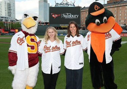 L-R: Sammy the Seagull / SU President Carolyn Ringer Lepre /O's President of Business Operations Catie Griggs / the Oriole Bird