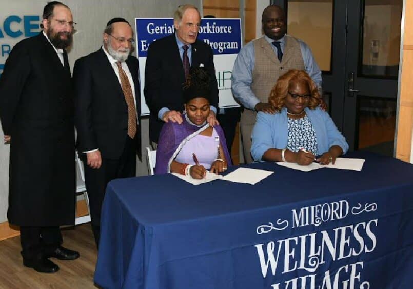 (Seated l-r) Dr. Kemi Ogunwusi of the Milford Wellness Village (MWV); and DSU's Dr. Gwen Scott-Jones, Dean of the College of Health and Behavioral Sciences, signed the partnership
agreement between Delaware State University and Education, Health and Research International, Inc. (EHRI) 

Standing (l-r) Rabbi Y. Halberstam, EHRI Director of Public Affairs; Meir Gelley, President of Nationwide Healthcare Services; U.S. Tom Carper, and DSU President Tony Allen.
Dr. Kemi, Director of MWV’s We Care Services, is also a 2012 DSU graduate.