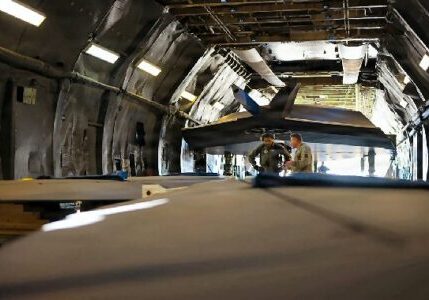 Tech. Sgt. Ryan Vaina, right, and Airman 1st Class Preston Pierce, 709th Airlift Squadron loadmasters, have a conversation within the cargo hold of C-5M Super Galaxy prior to takeoff from Palmdale, Calif., Oct. 6, 2026. The two discussed the securement strategy of two F-117A Nighthawk wings during a high-visibility mission / US Air Force photo by Staff Sgt. Alexis Morris