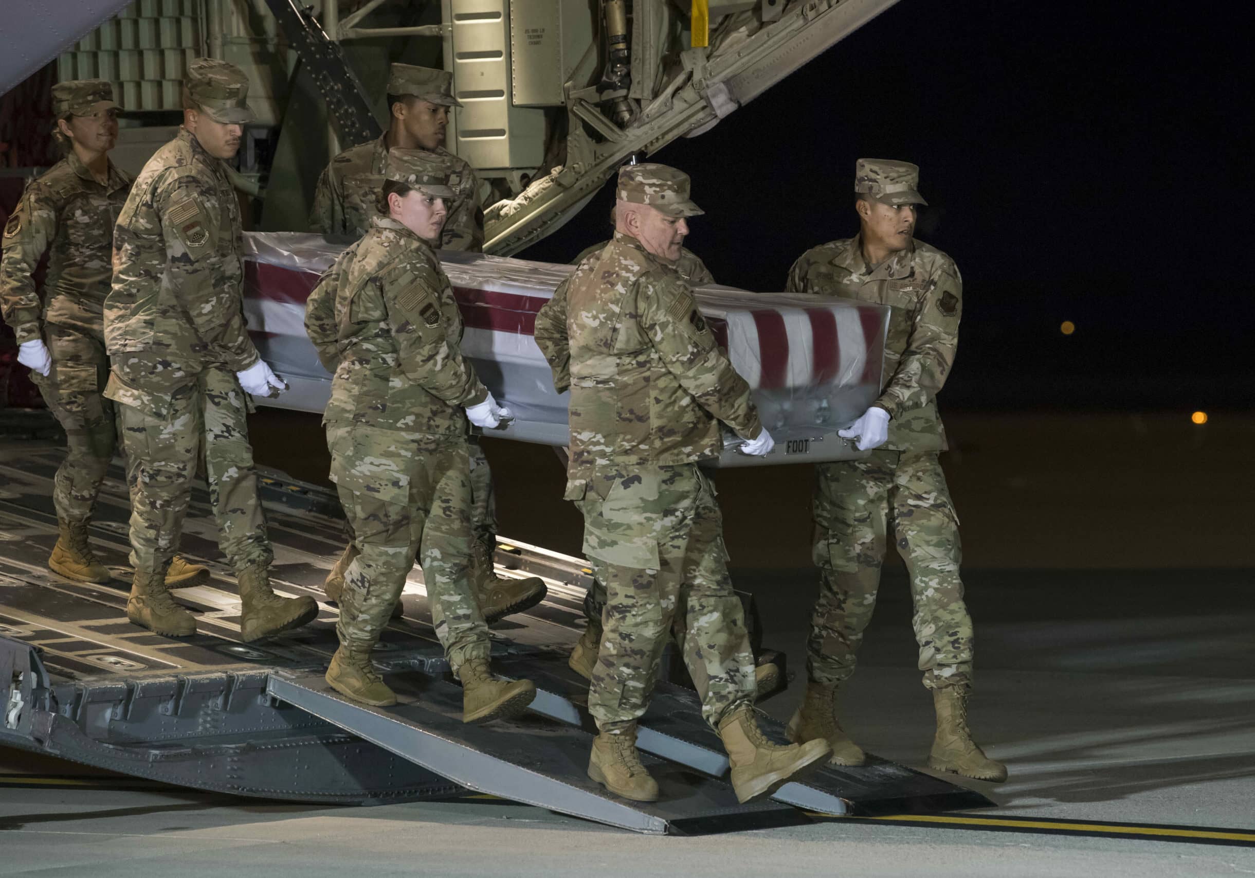 A U.S. Air Force carry team transfers the remains of Seaman Apprentice Cameron S. Walters, of Richmond Hill, Ga., at Dover Air Force Base, Del., Dec. 8, 2019. Walters was assigned to the Naval Aviation Schools Command, Naval Air Station Pensacola, Fla. (U.S. Air Force Photo by Senior Airman Christopher Quail)