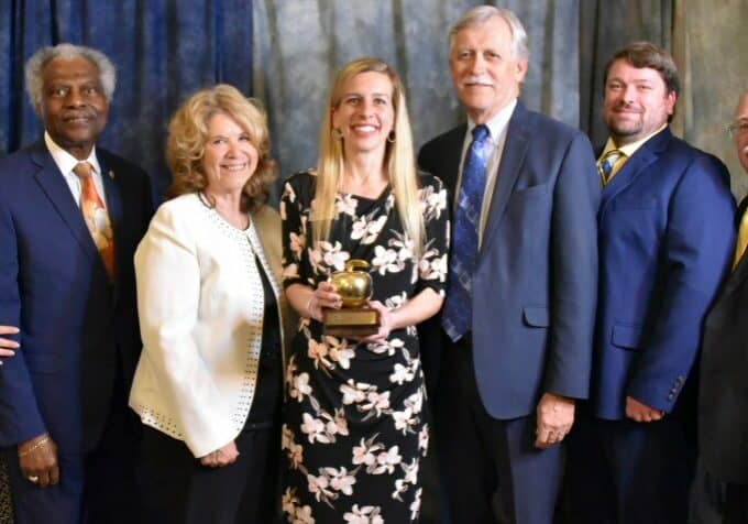 L-R:  Wicomico County Board of Education: Board member Susan Beauchamp, Vice Chairman Allen Brown, Board member Dr. Bonnie Ennis, Wicomico Teacher of the Year Tara Martens, Board Chairman Gene Malone, and Board members David Plotts and John Palmer