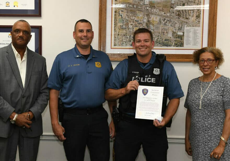 Pictured, from left, are SUPD Chief Edwin Lashley, Lt. Dan Calhoun, Baker and Dr. Janet Wormack, SU vice president of administration and finance. Photo courtesy of Salisbury University
