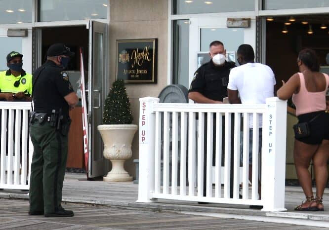 Police stop a man for a Covid violation (no face covering) at a checkpoint on the Rehoboth Beach boardwalk. Image courtesy WGMD/Alan Henney