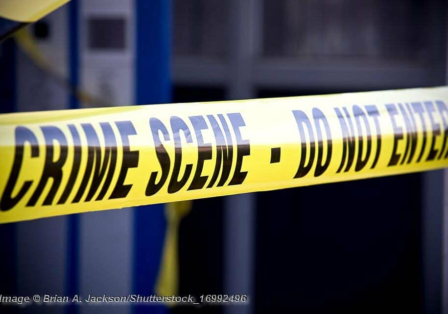 Close up crime scene investigation police boundary tape. © Brian A. Jackson/Shutterstock