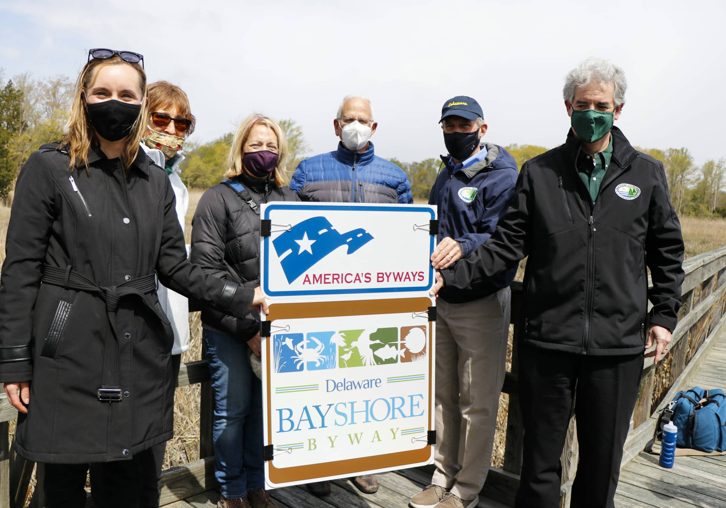 DelDOT Secretary Nicole Majeski, Ann Gravatt, Karen Bennett with DNREC Division of Fish and Wildlife, Chair of the Byway Management Team Steve Borleske, Governor John Carney and DNREC Secretary Shawn M. Garvin Unveiling National Scenic Byways Sign at the Delaware National Estuarine Research Reserve’s St. Jones Reserve in Dover