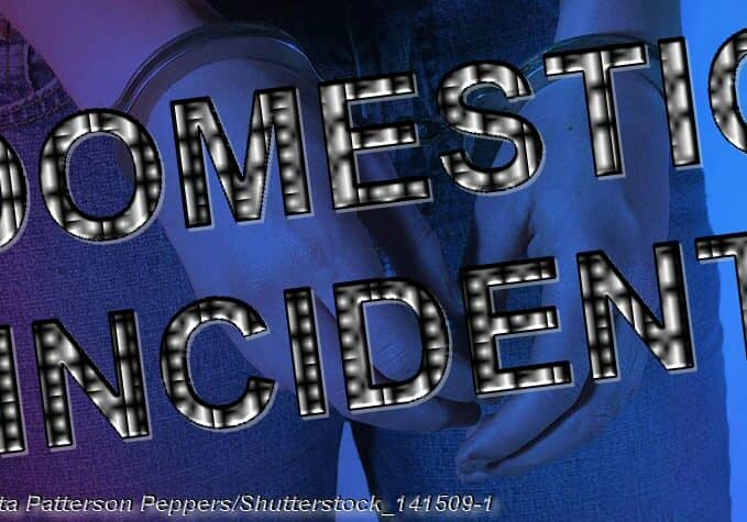 Young Women in Handcuffs with red and blue lighting © Anita Patterson Peppers/Shutterstock_141509-1