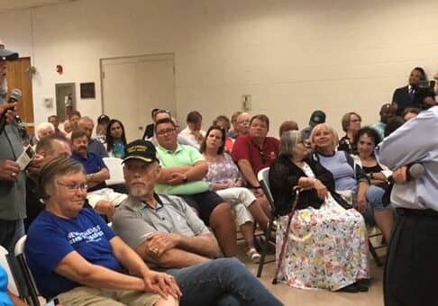 Sen. Coons takes a question on illegal immigration during a packed town hall in Milford, Delaware.