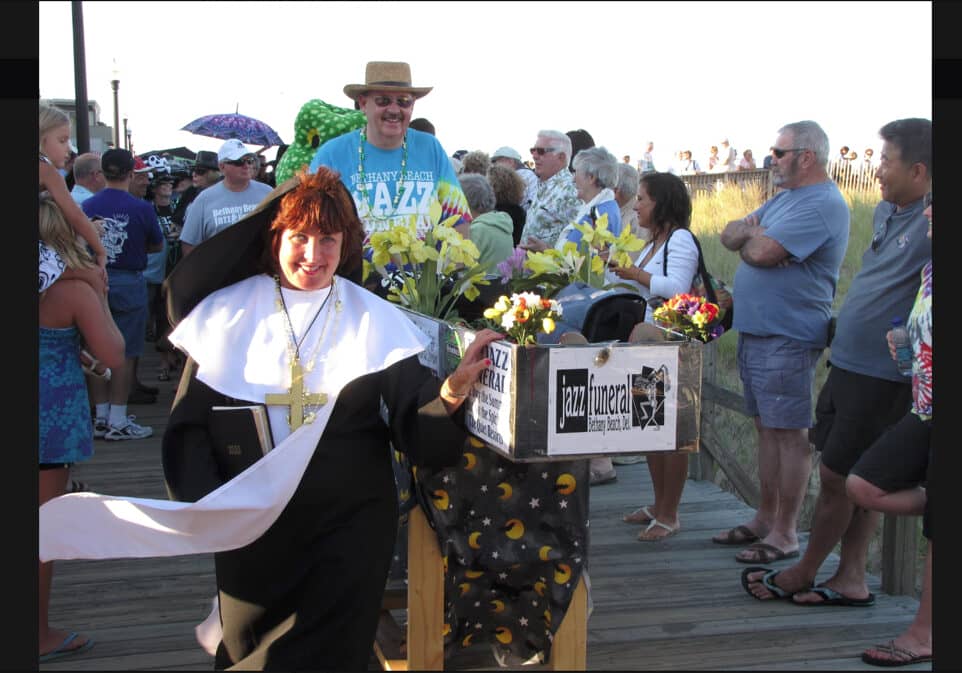 Bethany Beach Jazz Funeral chairwoman Marie Wright and Jazz chairman Paul Jankovic guide “Summer” to her final resting place at the Bethany Beach bandstand during the ceremonies to celebrate the end of the summer season in Bethany Beach, Del. (Submitted photo from Jazz Funeral graphic files)