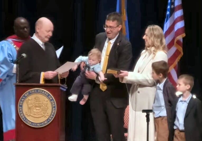 Justice Collins J. Seitz, Jr administers the Oath of Office to Governor Matt Meyer, son Levi decides he's ready for it to end - and gets handed off to his brother so the Oath of Office can be completed / Image courtesy Delaware.gov