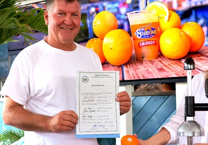 Steve 'Monty' Montgomery of The Starboard holds the signed bill that makes the Orange Crush Delaware's official cocktail. Image courtesy WGMD/Alan Henney
