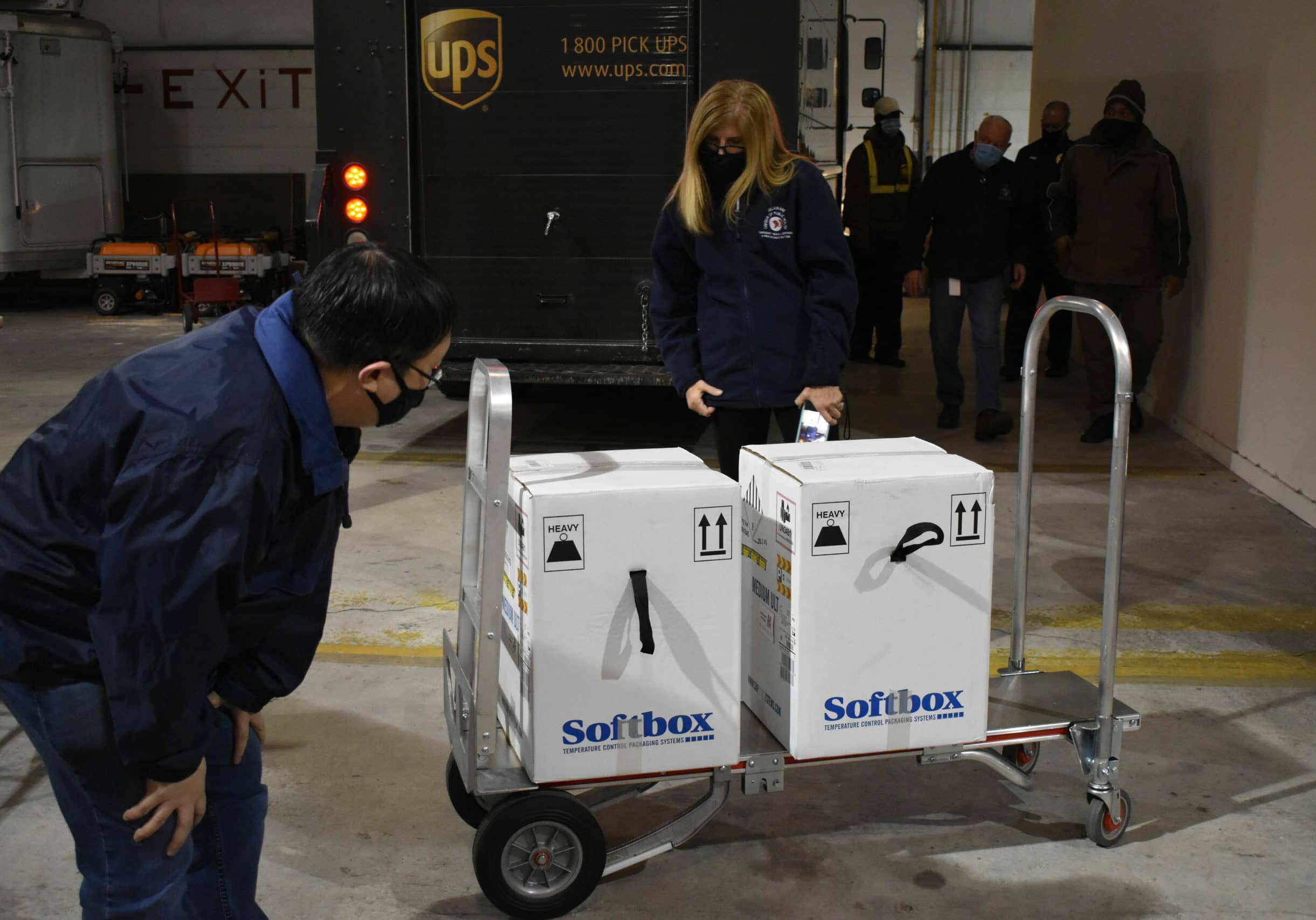 The Delaware Division of Public Health’s Medical Director Dr. Rick Hong looks over t he shipment of 7,800 doses of Pfizer vaccine as it arrives at the DPH warehouse on Wednesday, Dec. 16, 2020 (photo courtesy of Delaware Public Health)