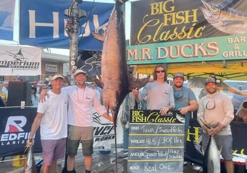 Peter Schultz, second from left, and his team stand with the new state record swordfish. Photo courtesy Big Fish Classic, used with permission.