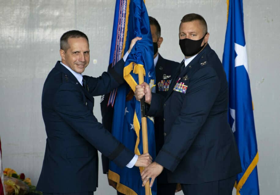 Col. Douglas A. Stouffer accepts the 512th Airlift Wing organizational flag from Maj. Gen. Jeffrey Pennington, 4th Air Force commander, during an assumption of command ceremony Oct. 16, 2021, at Dover Air Force Base, Del. The passing of the flag signifies the start of Stouffer’s command of the wing. (U.S. Air Force photo by Tech. Sgt. Zachary Cacicia)