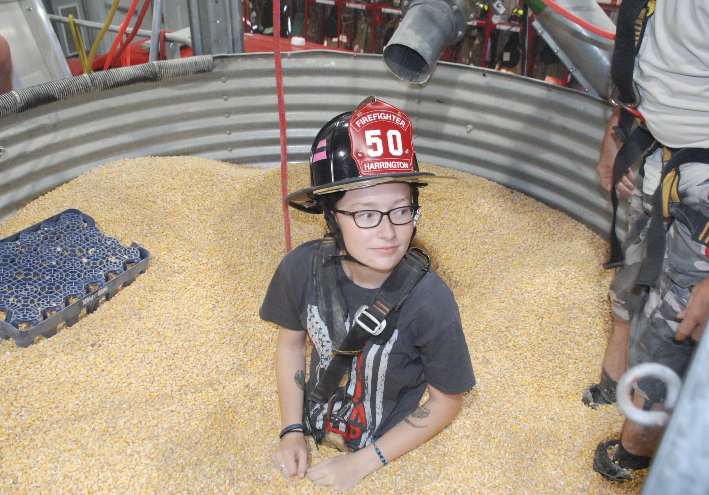 Volunteer firefighter Makayla Parson helped demonstrate how the grain bin rescue tube works last year at the Harrington Fire Department after they received the award from Nationwide.